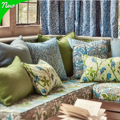 Stylish Green and Blue designer fabric pillows on matching sofa